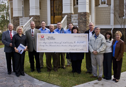Idea House Team Presents Check to Charity