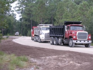 Trucks Prepare Road for Paving in Seawatch